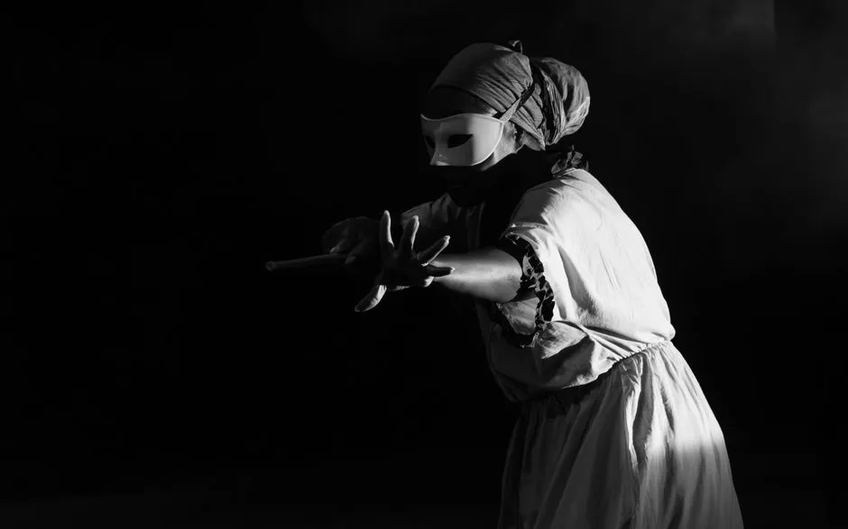 A black-and-white theatrical stage performance, illustrative of classic theatre